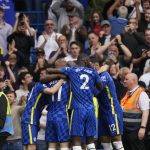 
              Chelsea's Romelu Lukaku, covered by his teammates, celebrates after scoring his side's second goal during the English Premier League soccer match between Chelsea and Wolverhampton at Stamford Bridge stadium, in London, Saturday, May 7, 2022. (AP Photo/Frank Augstein)
            