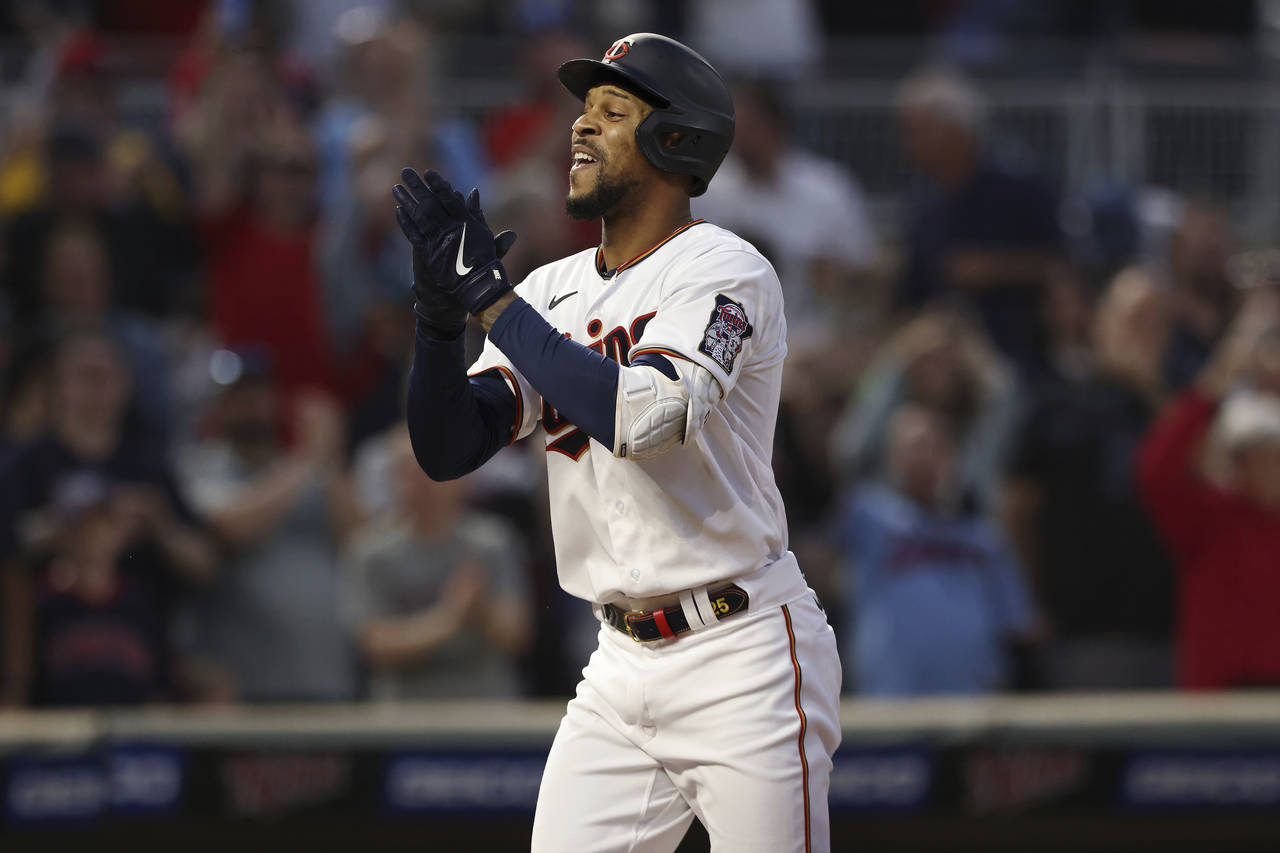 Minnesota Twins designated hitter Byron Buxton reacts on his way to home base after hitting a home ...