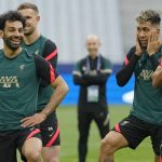 
              Liverpool's Mohamed Salah, left, smiles as Liverpool's Alex Oxlade-Chamberlain, right, and Liverpool's Roberto Firmino look on during a training session at the Stade de France in Saint Denis near Paris, Friday, May 27, 2022. Liverpool and Real Madrid are making their final preparations before facing each other in the Champions League final soccer match on Saturday. (AP Photo/Manu Fernandez)
            