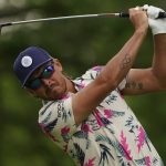 
              Rickie Fowler watches his tee shot on the 14th hole during a practice round for the PGA Championship golf tournament, Tuesday, May 17, 2022, in Tulsa, Okla. (AP Photo/Matt York)
            