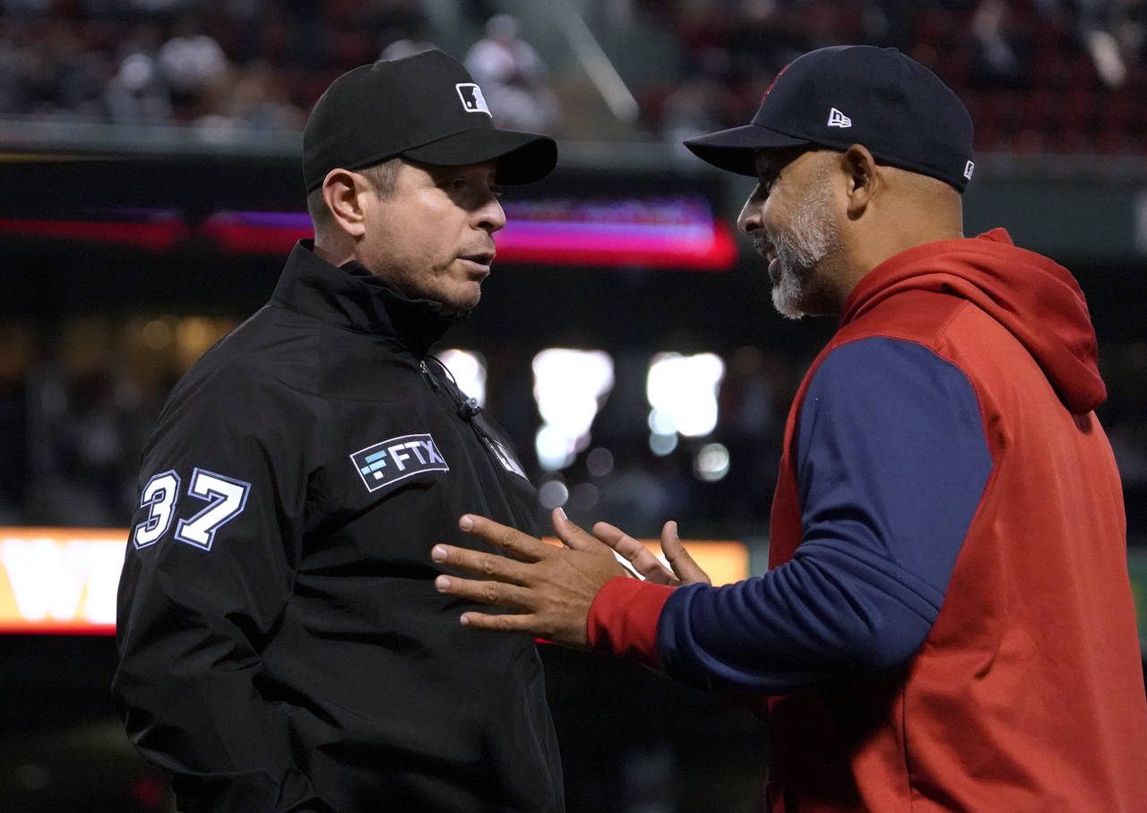 Boston Red Sox manager Alex Cora, right, argues a call with umpire Carlos Torres during the fifth i...