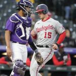 
              Washington Nationals' Riley Adams, back, scores on a single hit by Cesar Hernandez as Colorado Rockies catcher Elias Diaz looks for a throw in the third inning of a baseball game Wednesday, May 4, 2022, in Denver. (AP Photo/David Zalubowski)
            
