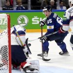 
              Sakari Manninen, center, of Finland tries to score against goalkeeper Strauss Mann of USA during the 2022 IIHF Ice Hockey World Championships preliminary round group B match between Finland and USA in Tampere, Finland, Monday May 16, 2022. (Vesa Moilanen/Lehtikuva via AP)
            