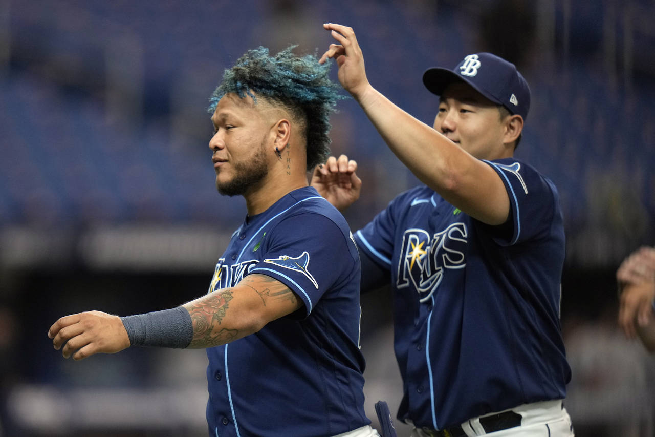 Tampa Bay Rays' Ji-Man Choi, right, touches Harold Ramirez's hair after the Rays defeated the Miami...