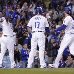 
              Los Angeles Dodgers' Max Muncy, center, and Cody Bellinger, right, congratulate each other after they scored on a single by Chris Taylor as Hanser Alberto celebrates during the second inning of a baseball game against the San Francisco Giants Tuesday, May 3, 2022, in Los Angeles. (AP Photo/Mark J. Terrill)
            