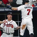 
              Atlanta Braves' Dansby Swanson (7) is greeted by manager Brian Snitker after scoring on a wild pitch and a fielding error during the fifth inning of the team's baseball game against the Philadelphia Phillies on Wednesday, May 25, 2022, in Atlanta. (AP Photo/John Bazemore)
            