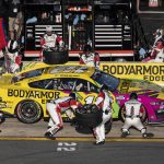 
              The pit crew of Ryan Blaney (12) rushes to complete a pit stop during a NASCAR Cup Series auto race at Charlotte Motor Speedway, Sunday, May 29, 2022, in Concord, N.C. (AP Photo/Matt Kelley)
            