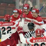 
              Denmark's team celebrates Mathias Bau, center, who just scored his side's third goal during the group A Hockey World Championship match between Canada and Denmark in Helsinki, Finland, Monday May 23 2022. (AP Photo/Martin Meissner)
            