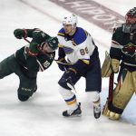 
              Minnesota Wild's Tyson Jost (10) tries to hold back St. Louis Blues' Pavel Buchnevich (89) as he and Wild goalie Marc-Andre Fleury, right, defend in the first period of Game 5 of an NHL hockey Stanley Cup first-round playoff series, Tuesday, May 10, 2022, in St. Paul, Minn. (AP Photo/Jim Mone)
            