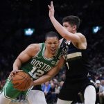 
              Boston Celtics forward Grant Williams (12) collides with Milwaukee Bucks guard Grayson Allen (7) on a drive to the basket in the second half of Game 2 of an Eastern Conference semifinal in the NBA basketball playoffs Tuesday, May 3, 2022, in Boston. (AP Photo/Charles Krupa)
            
