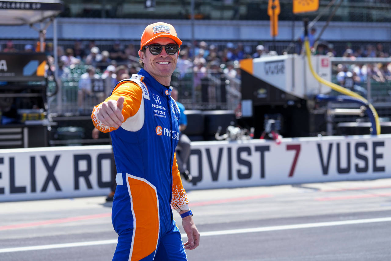 Scott Dixon, of New Zealand, walks to his car before the Indianapolis 500 auto race at Indianapolis...