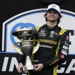 
              Colton Herta holds the trophy after winning an IndyCar auto race at Indianapolis Motor Speedway, Saturday, May 14, 2022, in Indianapolis. (AP Photo/Darron Cummings)
            