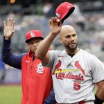 
              St. Louis Cardinals first baseman Albert Pujols (5) and catcher Yadier Molina acknowledge the New York Mets crowd during a pre-game ceremony before a baseball game on Thursday, May 19, 2022, in New York. (AP Photo/Adam Hunger)
            