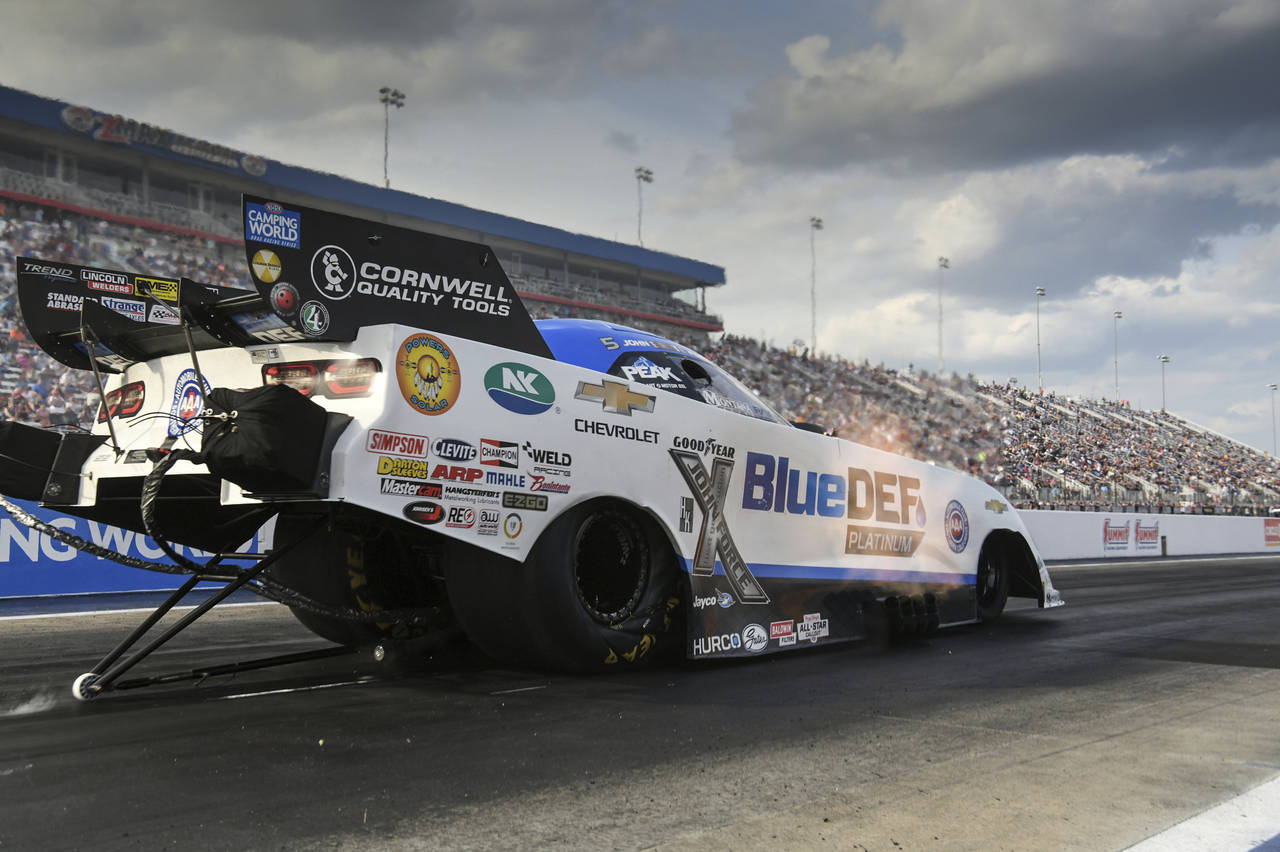 In this photo provided by the NHRA, John Force drives in Funny Car qualifying Saturday, April 30, 2...