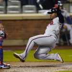 
              Atlanta Braves' Ozzie Albies, right, slides past New York Mets catcher James McCann to score during the sixth inning of a baseball game Monday, May 2, 2022, in New York. (AP Photo/Frank Franklin II)
            