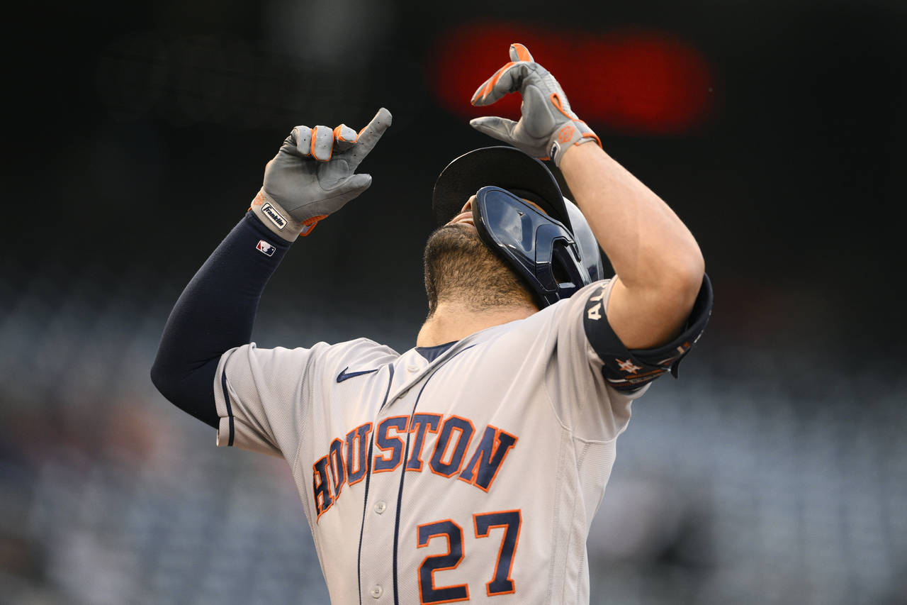 Houston Astros' Jose Altuve celebrates after his home run during the first inning of a baseball gam...