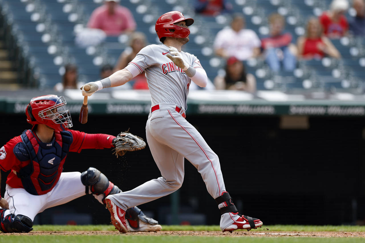 Cincinnati Reds' Tyler Naquin hits a single against the Cleveland Guardians during the eighth innin...