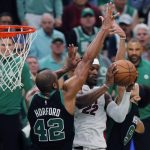 
              Boston Celtics' Al Horford (42) and Derrick White (9) double-team Miami Heat's Jimmy Butler (22) during the second half of Game 6 of the NBA basketball playoffs Eastern Conference finals Friday, May 27, 2022, in Boston. (AP Photo/Michael Dwyer)
            