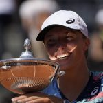 
              Poland's Iga Swiatek holds the trophy after winning the final match against Turkey's Ons Jabeur at the Italian Open tennis tournament, in Rome, Sunday, May 15, 2022. (AP Photo/Alessandra Tarantino)
            