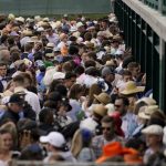 
              Fans stand at betting windows in the infield before the 148th running of the Kentucky Derby horse race at Churchill Downs Saturday, May 7, 2022, in Louisville, Ky. (AP Photo/Brynn Anderson)
            