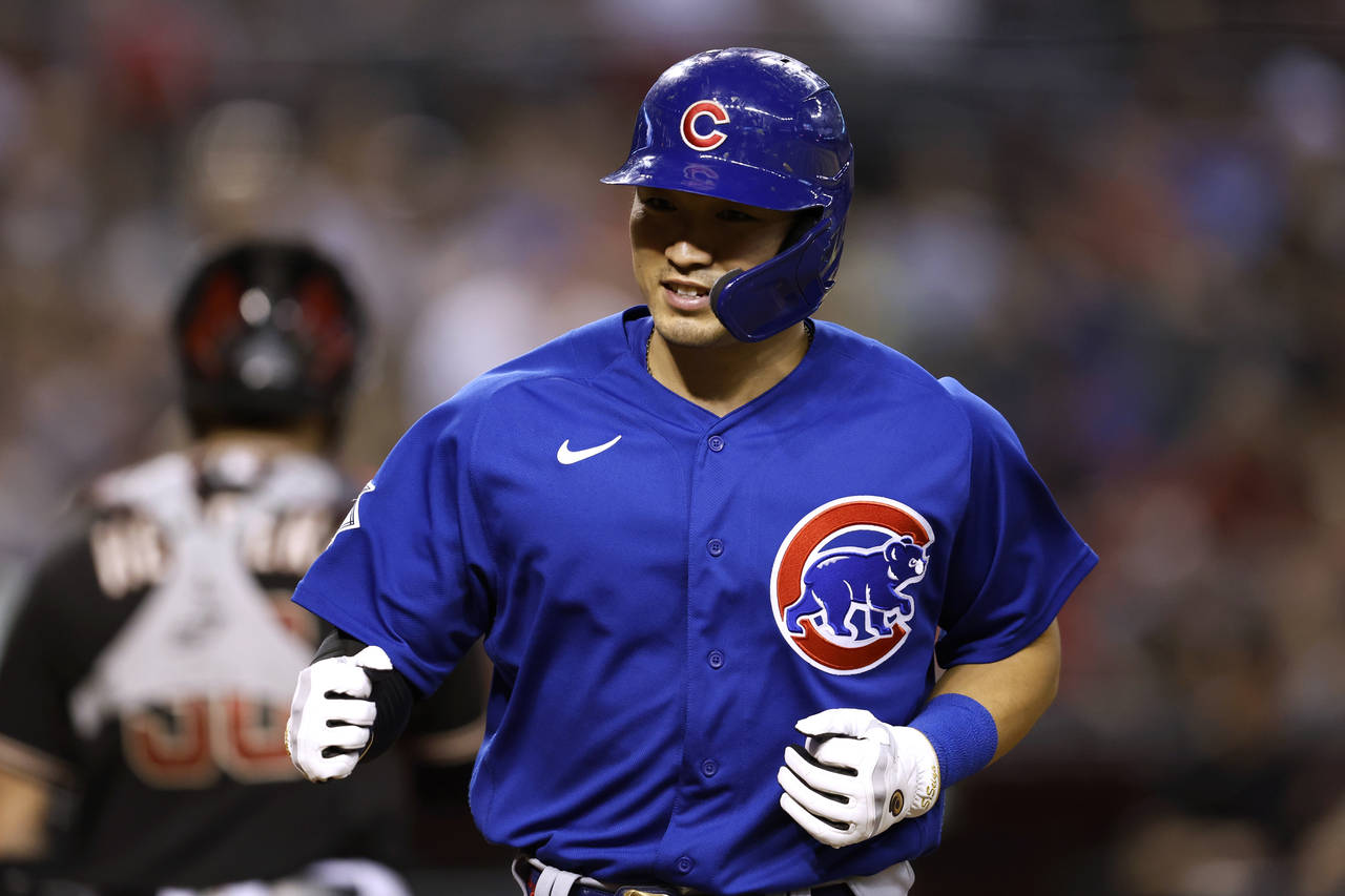 Chicago Cubs' Seiya Suzuki scores a run on a walk during the ninth inning of the team's baseball ga...