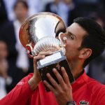 
              Serbia's Novak Djokovic kisses the trophy after winning the final match against Greece's Stefanos Tsitsipas at the Italian Open tennis tournament, in Rome, Sunday, May 15, 2022. (AP Photo/Alessandra Tarantino)
            