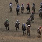 
              Rich Strike, with Sonny Leon aboard, lower right, lead the pack as they cross the finish line to win the 148th running of the Kentucky Derby horse race at Churchill Downs Saturday, May 7, 2022, in Louisville, Ky. (AP Photo/Charlie Riedel)
            