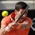 
              Novak Djokovic returns the ball to Aslan Karatsev during their match at the Italian Open tennis tournament, in Rome, Tuesday, May 10, 2022. (AP Photo/Andrew Medichini)
            