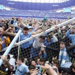 
              Manchester City fans invade the pitch after their side won the English Premier League following a 3-2 victory over Aston Villa at The Etihad Stadium, Manchester, England, Sunday, May 22, 2022. (Martin Rickett/PA via AP)
            