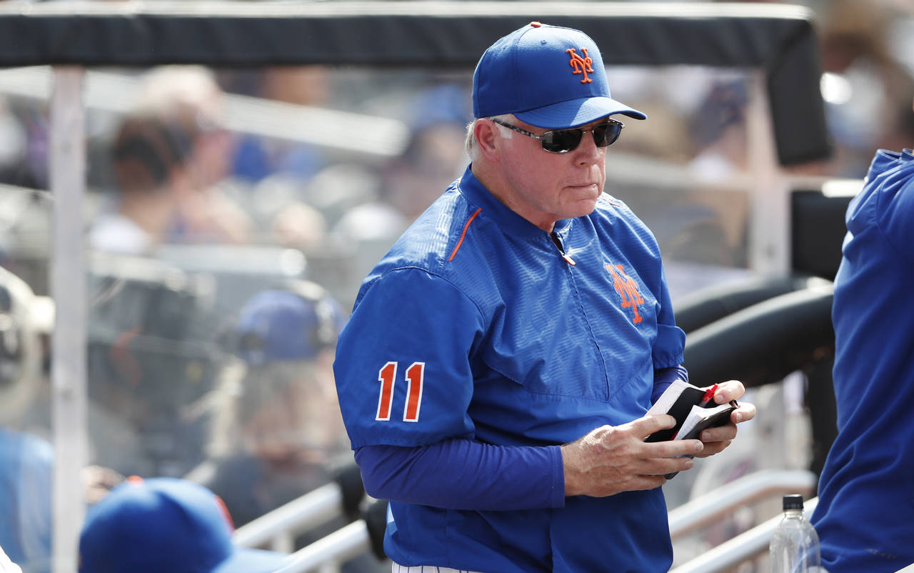 New York Mets manager Buck Showalter (11) stands in the dugout during a baseball game against the S...