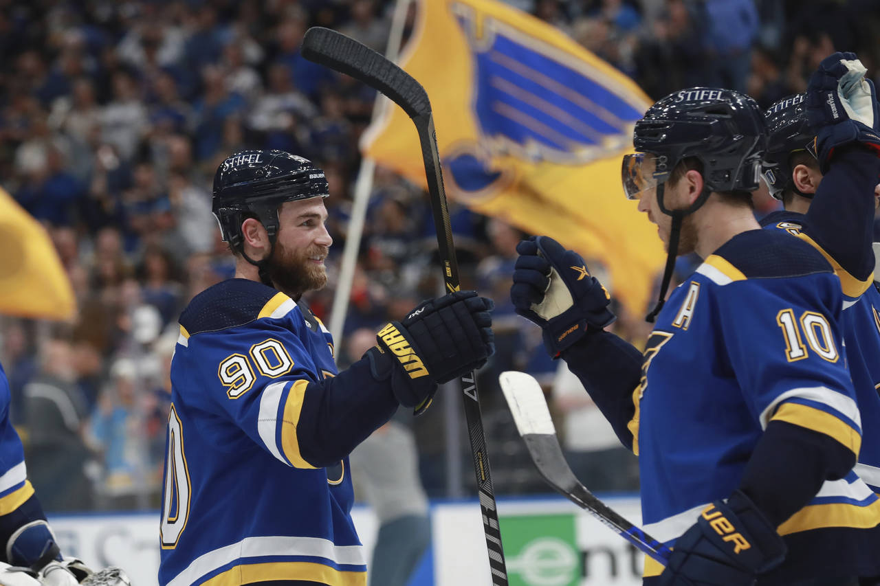 St. Louis Blues' Ryan O'Reilly (90) and Brayden Schenn (10) celebrate after the Blues defeated the ...