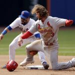 
              New York Mets shortstop Luis Guillorme tags out St. Louis Cardinals' Brendan Donovan (33) who was attempting to steal the base during the seventh inning of a baseball game on Thursday, May 19, 2022, in New York. (AP Photo/Adam Hunger)
            