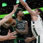 
              Boston Celtics guard Marcus Smart, center, drives toward the basket past Milwaukee Bucks guard Grayson Allen, left, and center Brook Lopez, right, in the second half of Game 1 in the second round of the NBA Eastern Conference playoff series, Sunday, May 1, 2022, in Boston. (AP Photo/Steven Senne)
            
