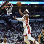 
              Miami Heat forward Jimmy Butler (22) drives to the basket during the first half of Game 5 of the NBA basketball Eastern Conference finals playoff series against the Boston Celtics, Wednesday, May 25, 2022, in Miami. (AP Photo/Lynne Sladky)
            