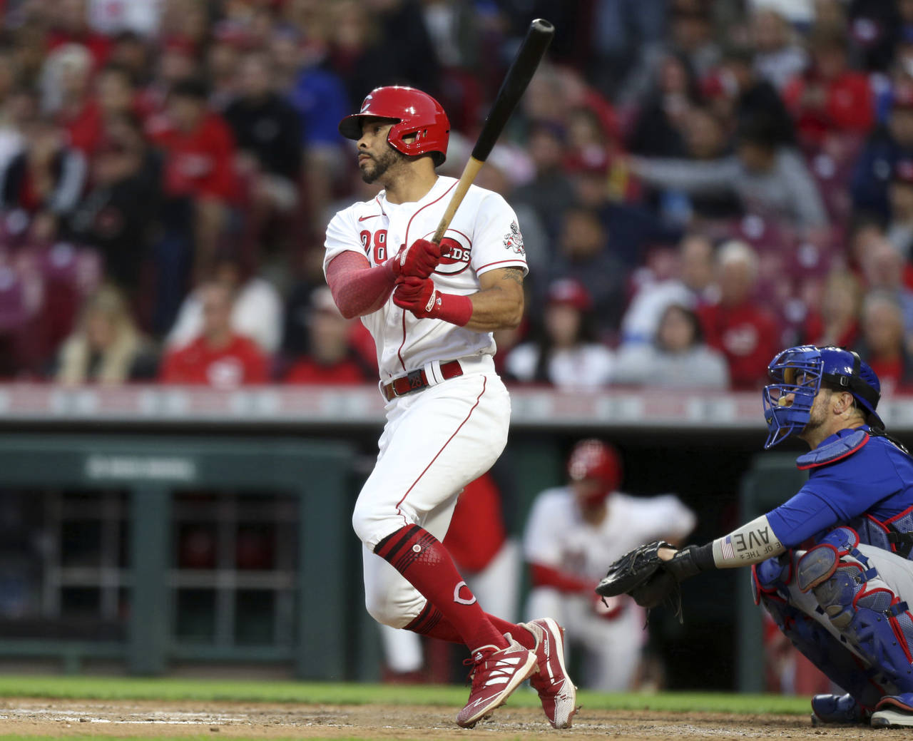 Cincinnati Reds' Tommy Pham, left, watches his home run in front of Chicago Cubs catcher Yan Gomes ...