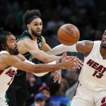 
              Boston Celtics' Derrick White loses control of the ball between Miami Heat's Gabe Vincent (2) and Bam Adebayo (13) during the first half of Game 6 of the NBA basketball playoffs Eastern Conference finals Friday, May 27, 2022, in Boston. (AP Photo/Michael Dwyer)
            