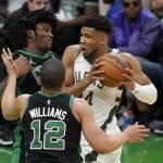 
              Milwaukee Bucks forward Giannis Antetokounmpo, right, of Greece, looks for an opening around Boston Celtics center Robert Williams III, top left, and forward Grant Williams (12) in the second half of Game 1 in the second round of the NBA Eastern Conference playoff series, Sunday, May 1, 2022, in Boston. (AP Photo/Steven Senne)
            
