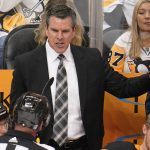 
              Pittsburgh Penguins coach Mike Sullivan talks with official Kevin Pollock during the third period in Game 6 of the team's NHL hockey Stanley Cup first-round playoff series against the New York Rangers in Pittsburgh, Friday, May 13, 2022. The Rangers won 5-3. (AP Photo/Gene J. Puskar)
            