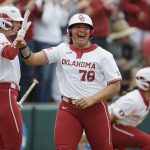 
              Oklahoma's Jocelyn Alo (78) celebrates with Jana Johns (20) after scoring a run against Texas A&M in the first inning of a softball game in the NCAA Norman Regional in Norman, Okla., Sunday, May 22, 2022. (Bryan Terry/The Oklahoman via AP)
            