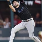 
              Miami Marlins third baseman Brian Anderson catches a fly ball by Atlanta Braves' Dansby Swanson during the fourth inning of a baseball game Friday, May 27, 2022, in Atlanta. (AP Photo/John Bazemore)
            