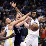 
              Dallas Mavericks' Luka Doncic is fouled by Stephen Curry as Draymond Green and Andrew Wiggins watch during the second half of Game 3 of the NBA basketball playoffs Western Conference finals, Sunday, May 22, 2022, in Dallas. (Scott Strazzante/San Francisco Chronicle via AP)
            