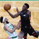
              Miami Heat guard Victor Oladipo, right, is fouled by Boston Celtics guard Derrick White, left, on a drive to the basket during the first half of Game 4 of the NBA basketball playoffs Eastern Conference finals, Monday, May 23, 2022, in Boston. (AP Photo/Charles Krupa)
            
