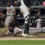 
              Baltimore Orioles' Cedric Mullins, left, slides home safely during the third inning of a baseball game against the New York Yankees, Monday May 23, 2022, in New York. (AP Photo/Bebeto Matthews)
            