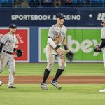 
              New York Yankees right fielder Aaron Judge, center, and relief pitcher Chad Green (57) celebrate after defeating the Toronto Blue Jays in nine innings of a baseball game in Toronto, Monday, May 2, 2022. (Christopher Katsarov/The Canadian Press via AP)
            