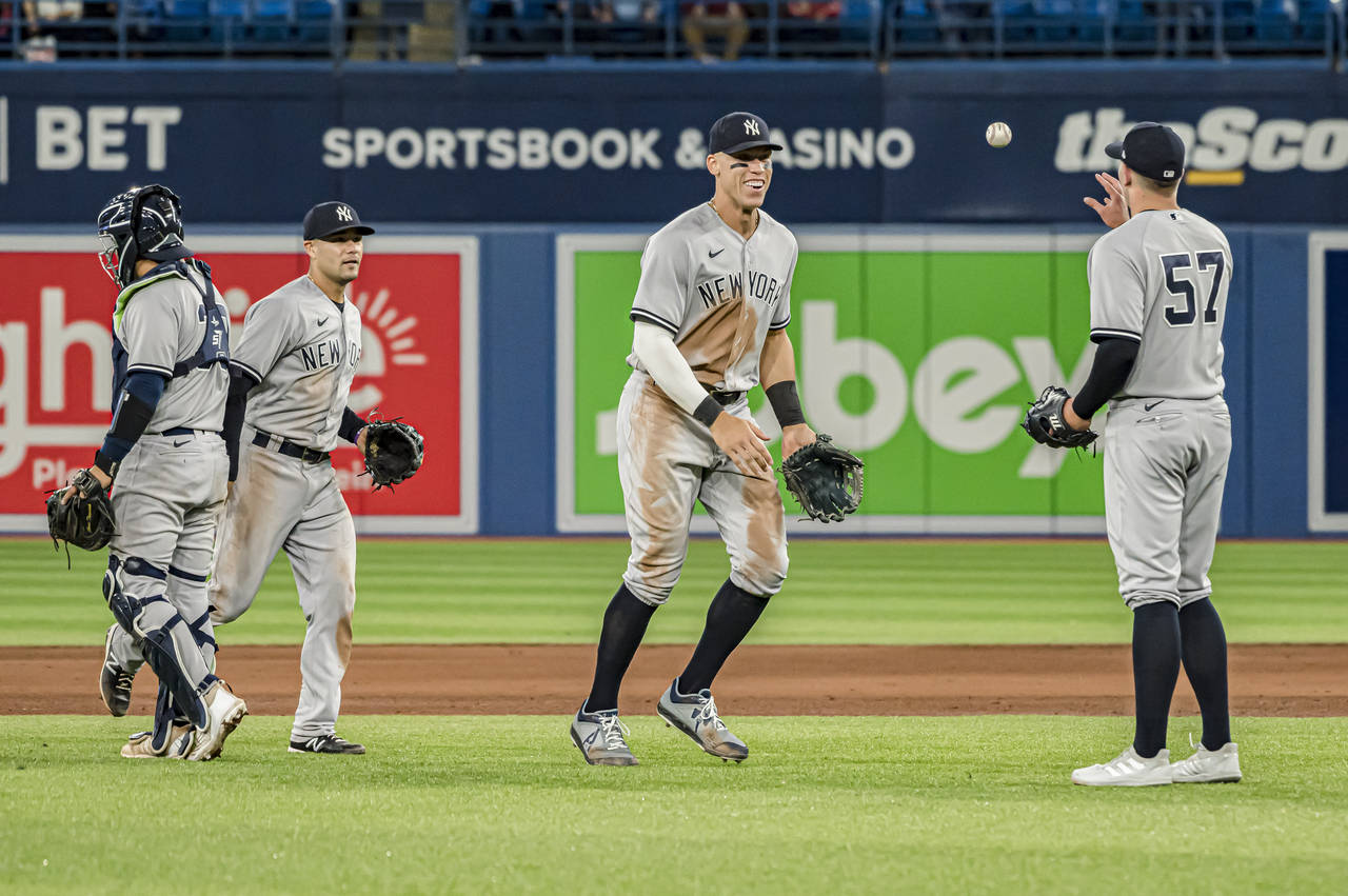New York Yankees right fielder Aaron Judge, center, and relief pitcher Chad Green (57) celebrate af...
