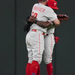 
              Philadelphia Phillies' Kyle Schwarber, left, and Roman Quinn, right, embrace after defeating the Atlanta Braves in a baseball game Monday, May 23, 2022, in Atlanta. (AP Photo/John Bazemore)
            