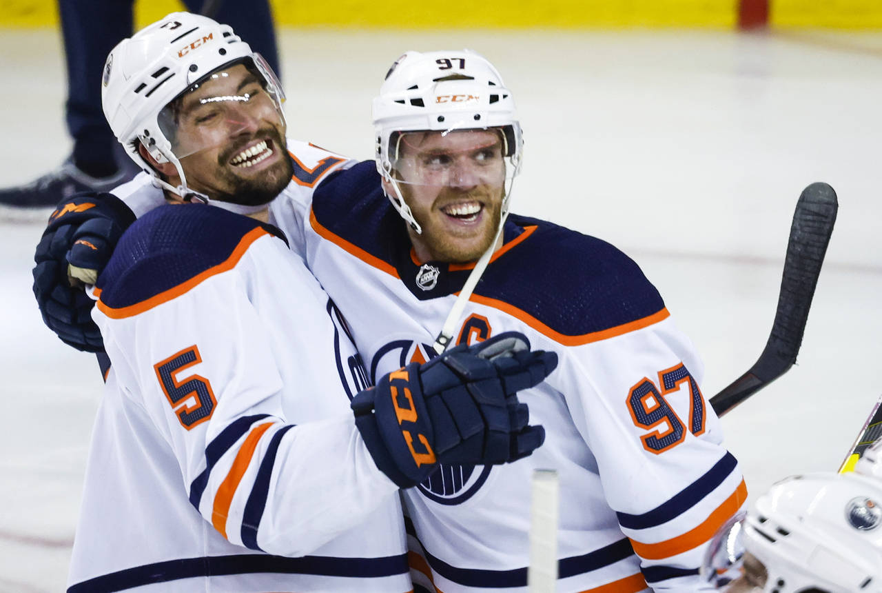 Edmonton Oilers center Connor McDavid, right, celebrates his goal against the Calgary Flames with d...