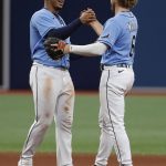 
              Tampa Bay Rays' Taylor Walls, right, celebrates with teammate Wander Franco after defeating the New York Yankees in a baseball game Sunday, May 29, 2022, in St. Petersburg, Fla. (AP Photo/Scott Audette)
            