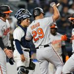 
              Baltimore Orioles' Adley Rutschman, left, and Ramon Urias, center, celebrate with Rougned Odor, right, after they scored on Odor's three-run home run during the seventh inning of the team's baseball game against the New York Yankees on Tuesday, May 24, 2022, in New York. (AP Photo/Frank Franklin II)
            