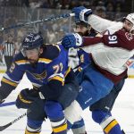 
              Colorado Avalanche's Nazem Kadri (91) collides with St. Louis Blues' Justin Faulk (72) during the first period in Game 3 of an NHL hockey Stanley Cup second-round playoff series Saturday, May 21, 2022, in St. Louis. (AP Photo/Jeff Roberson)
            